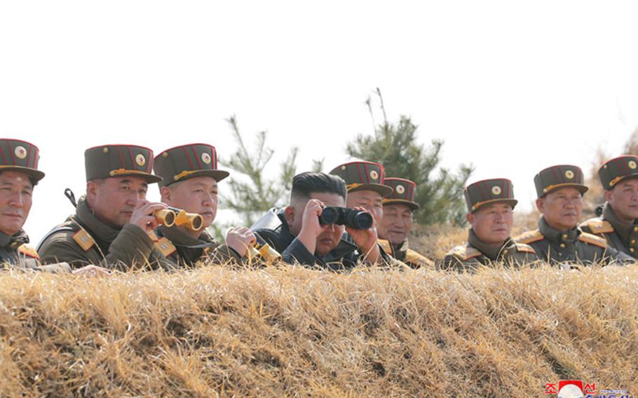 In this photo released Saturday, March 21, 2020 by the state-run Korean Central News Agency, North Korean leader Kim Jong Un watches as troops participate in an artillery fire competition between large combined Army units “on the western front” on Friday, March 20.