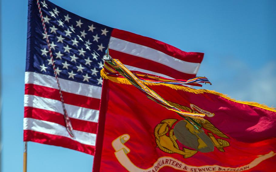 United States and Marine Corps flags fly during a change-of-command ceremony at Camp H.M. Smith, Hawaii, in July 2017.