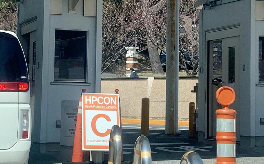 The health protection condition is displayed to drivers at the main gate to Yokosuka Naval Base, Japan, Thursday, March 26, 2020. 
