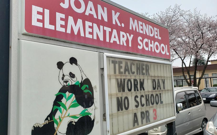 A sign outside Joan K. Mendel Elementary School announces an upcoming teacher work day at Yokota Air Base, Japan, Tuesday, March 31, 2020.