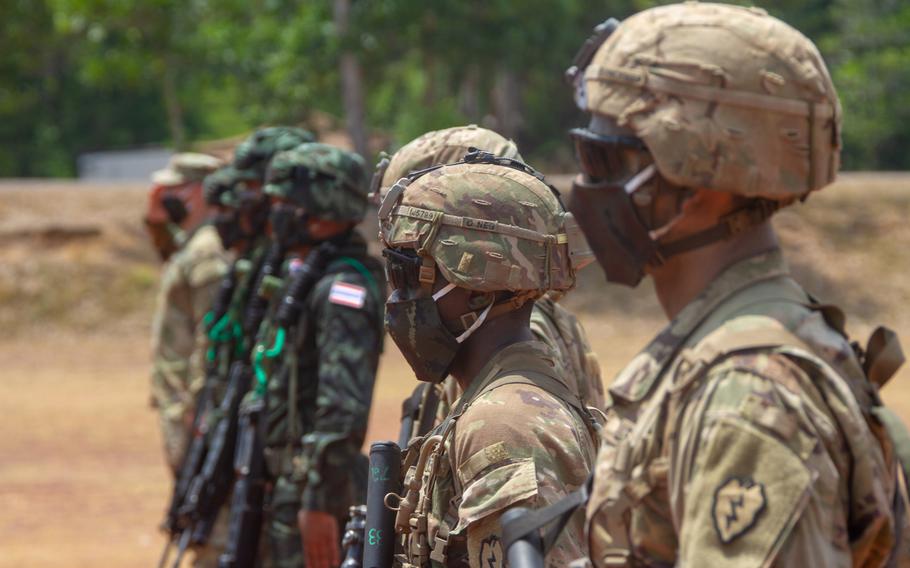 Thai and U.S. soldiers, wearing masks to reduce the risk of coronavirus infection, stand at attention at Krabi, Thailand, during the opening ceremony of the Hanuman Guardian exercise, March 30, 2020.