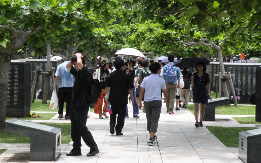 Attendees of Okinawa's annual Irei no Hi ceremony pay their respects at Peace Memorial Park's Cornerstone of Peace memorial to lives lost during the Battle of Okinawa on June 23, 2018.