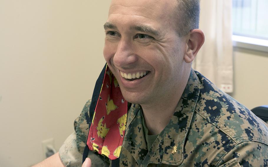 Maj. Jared Blake of the III Marine Expeditionary Force Information Group shows off the Pikachu characters hidden on this inside of his face mask at Camp Hansen, Okinawa, Tuesday, April 21, 2020.