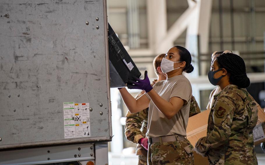Airmen with the Pacific Air Forces postal squadron process mail at Yokota Air Base, Japan, April 17, 2020.
