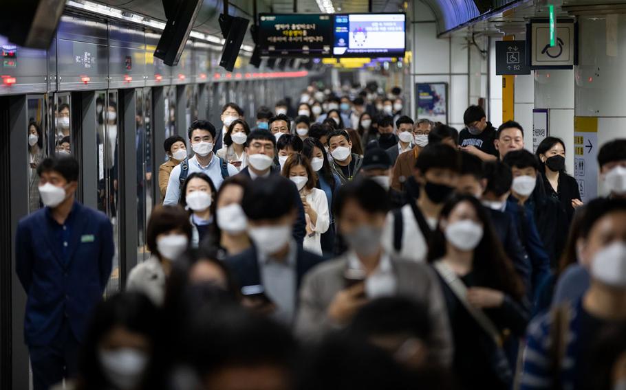 Passengers in a subway station in Seoul, South Korea, on May 18, 2020. 
