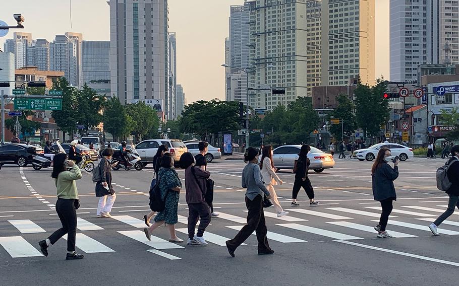 Pedestrians cross the street in Seoul, South Korea, on Thursday, May 28. 