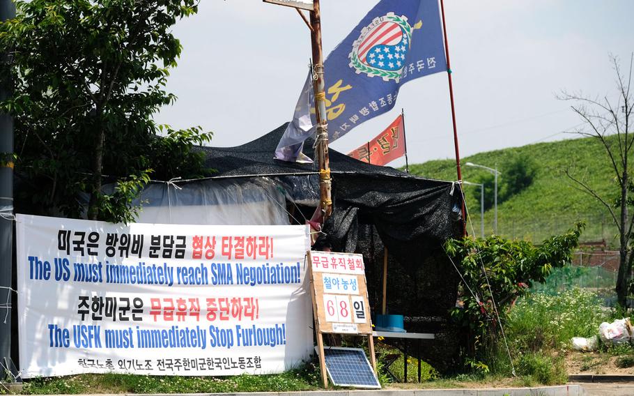 A banner outside Camp Humphreys calls for the end of furloughs for locals working for U.S. Forces Korea, Wednesday, June 3, 2020.
