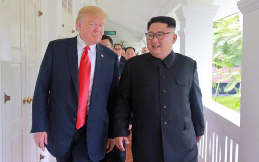President Donald Trump walks with North Korean leader Kim Jong Un at the Capella Hotel in Singapore, June 18, 2018, in this picture released by the Korean Central News Agency.