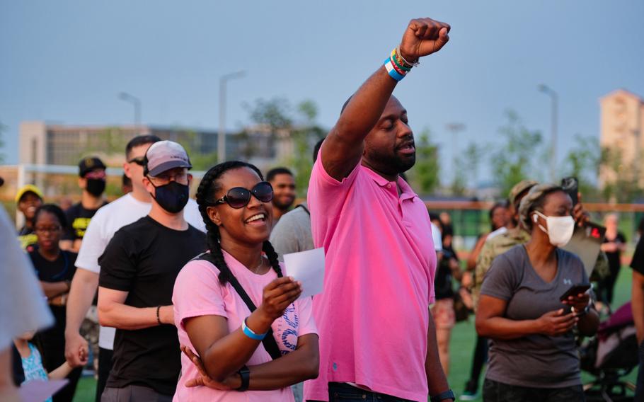 People listen and sing along to a performance of "Lift Every Voice and Sing" during the inaugural Juneteenth celebration at Camp Humphreys, South Korea, Friday, June 19, 2020. 
