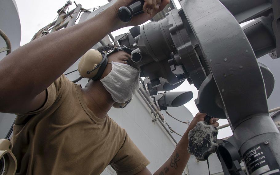 Seaman Patrick Harris of Columbia, S.C., stands forward lookout watch on the signal bridge of the aircraft carrier USS Ronald Reagan in the Philippine Sea, June 25, 2020.