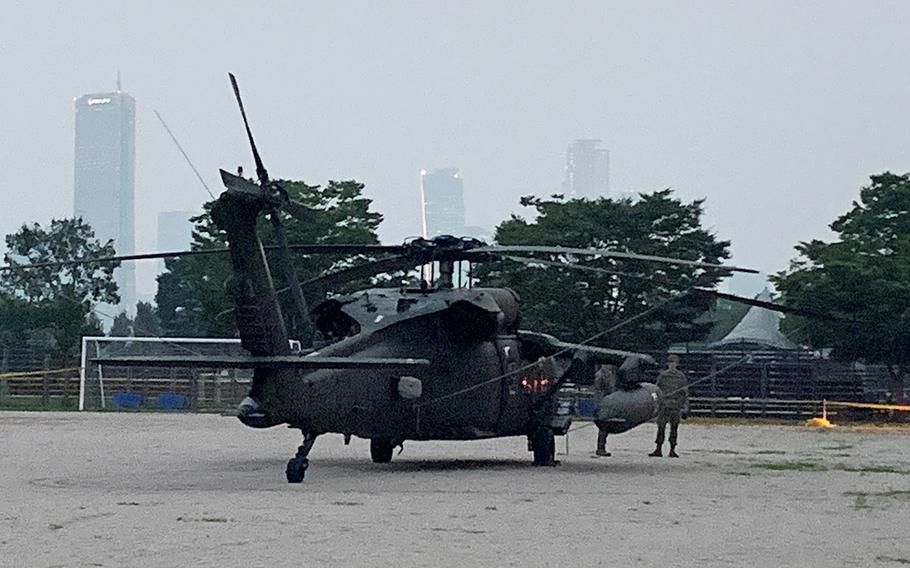 A UH-60 Black Hawk helicopter sits in an empty field in a riverside park hours after it made a "precautionary landing" hours earlier in Seoul, South Korea, on Thursday, July 2.