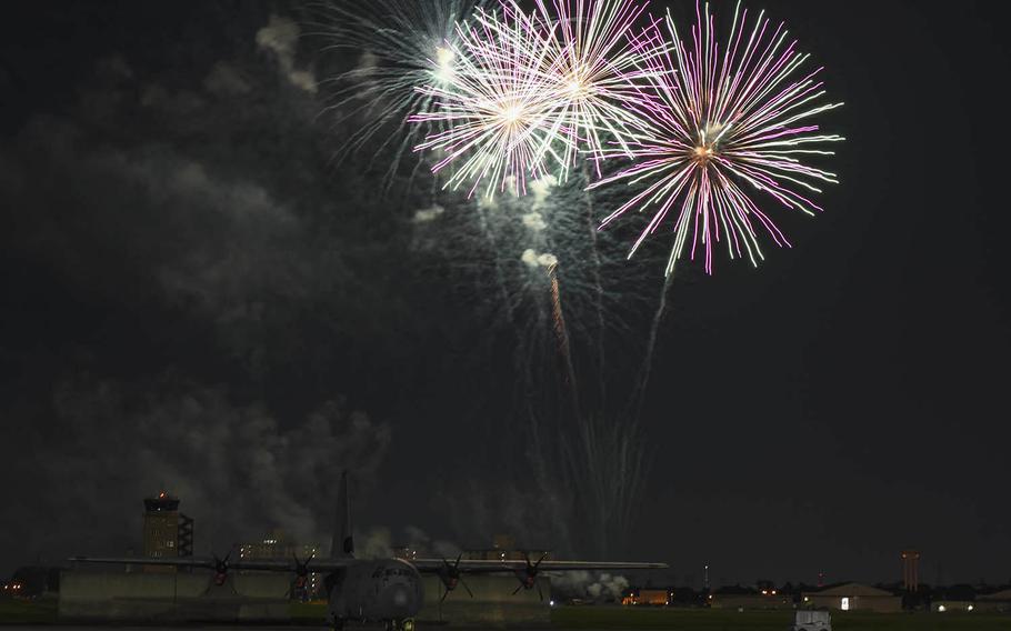 Fireworks explode behind a C-130J Super Hercules at Yokota Air Base, Japan, Thursday, July 2, 2020. 