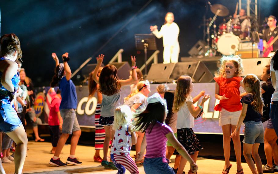 Children dance during a live musical performance by local band Street Beat during Liberty Fest 2020 on Osan Air Base, South Korea, Saturday, July 4, 2020.