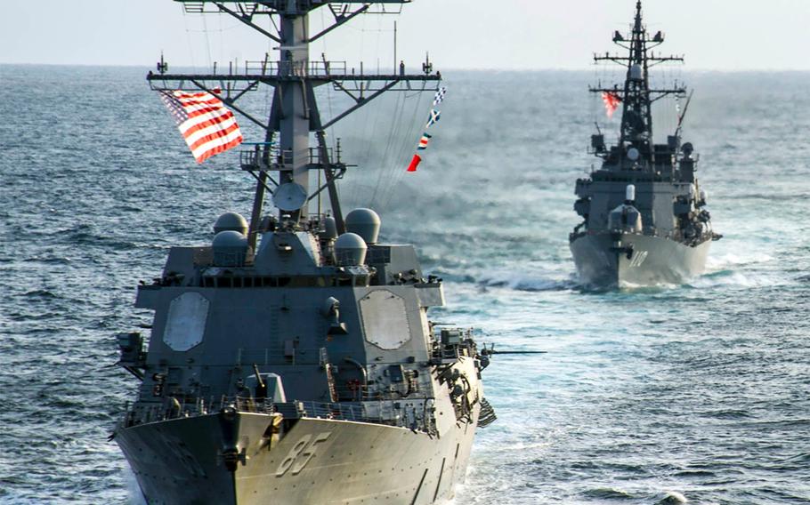 The guided-missile destroyer USS McCampbell, left, and the JMSDF destroyer Takanami sail together in the Pacific Ocean on March 9, 2014.