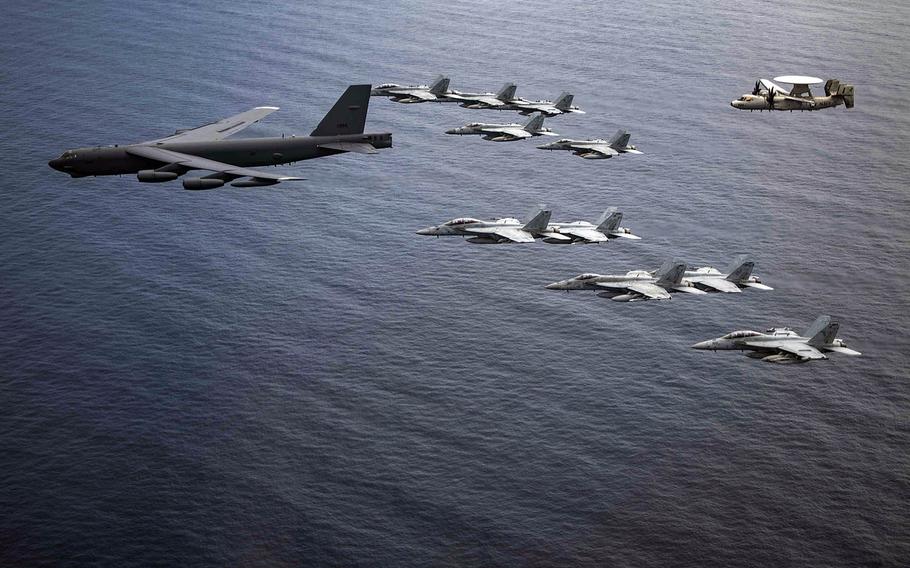 Aircraft from the USS Nimitz and a B-52 Stratofortress from Barksdale Air Force Base, La., fly in formation in the South China Sea in this undated phtograph.  












