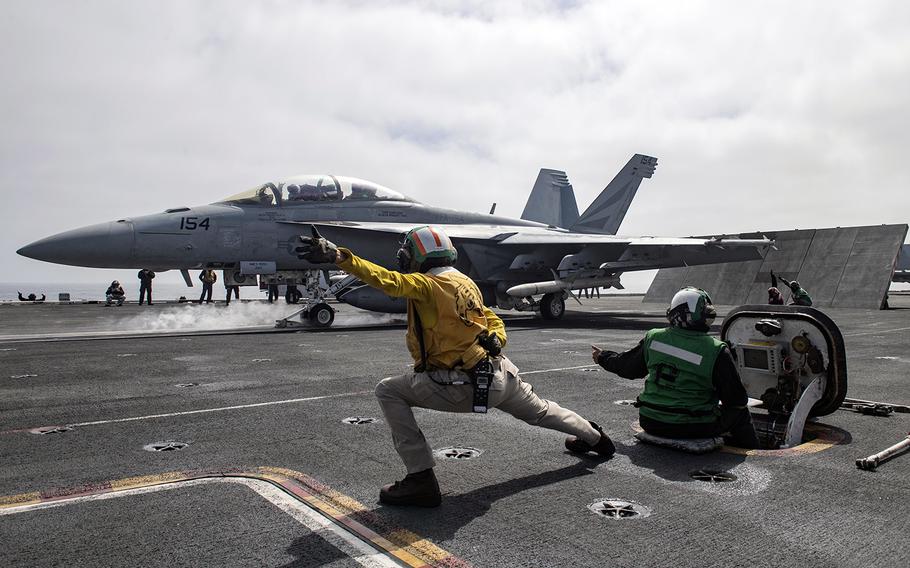 An F/A-18F Super Hornet assigned to the Black Knights of Strike Fighter Squadron 154 launches from the flight deck of the aircraft carrier USS Theodore Roosevelt somewhere in the Pacific Ocean, July 7, 2020.