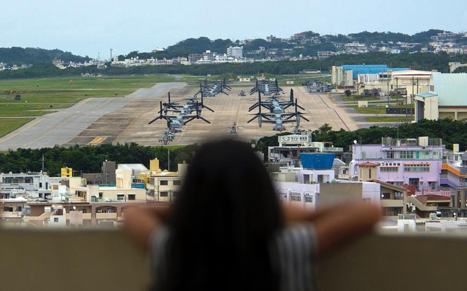 A child looks out at aircraft at Marine Corps Air Station Futenma, Okinawa, April 19, 2019.