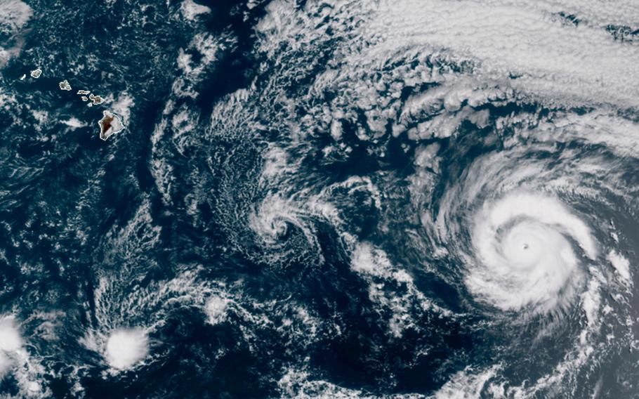 This GOES-17 taken at 3:30 p.m. EDT, Thursday, July 23, 2020, shows Hurricane Douglas, right, churning in the Pacific Ocean heading towards Hawaii, left. The storm is currently a Category 3 hurricane but is expected to weaken before it arrives in the state this weekend. 