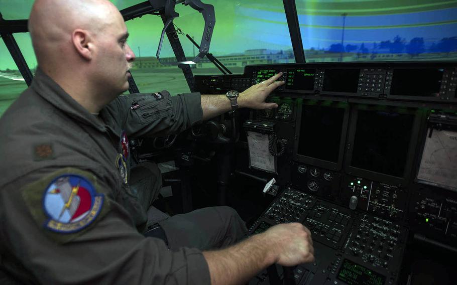 Maj. Chris Wolff, assistant director of operations for the 374th Airlift Wing's Operations Support Squadron, gives a tour inside the new C-130J Super Hercules flight simulator at Yokota Air Base, Japan, Monday, July 27, 2020.