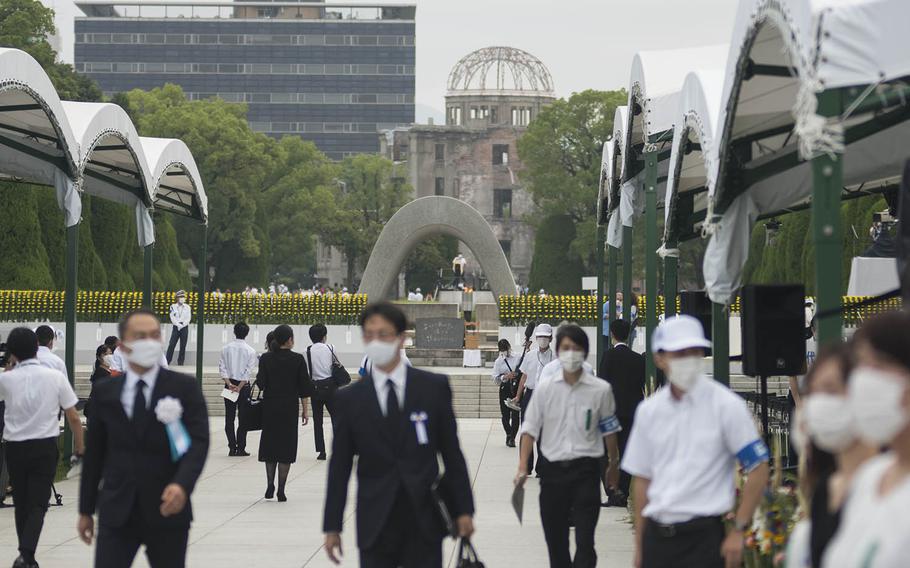 People gather at Hiroshima Peace Memorial Park, Thursday, Aug. 6, 2020, to mark the atomic bombing's 75th anniversary. 
