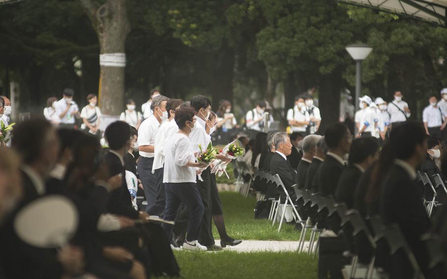 People gather at Hiroshima Peace Memorial Park, Thursday, Aug. 6, 2020, for a ceremony marking the 75th anniversary of the atomic bombing.