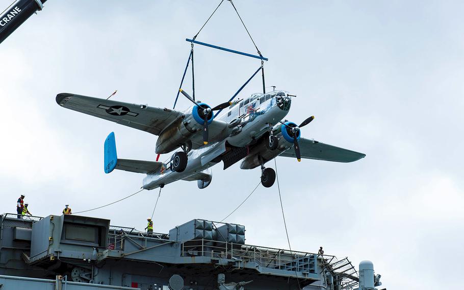 A B-25 Mitchell bomber is unloaded from the USS Essex in Pearl Harbor, Hawaii, Aug. 10, 2020. The USS Alabama Battleship Memorial Park, which has the 35,000-ton battleship as its centerpiece in Mobile, also has a collection of military weapons and aircraft, including a B-25 Mitchell bomber that has been in the park’s collection since the late 1970s.