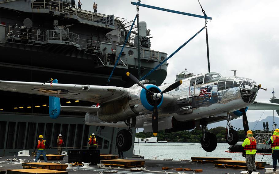 A B-25 Mitchell bomber, the same kind of aircraft flown in the historic Doolittle Raid in April 1942, is unloaded from the USS Essex at Joint Base Pearl Harbor-Hickam, Hawaii, Aug. 11, 2020. 