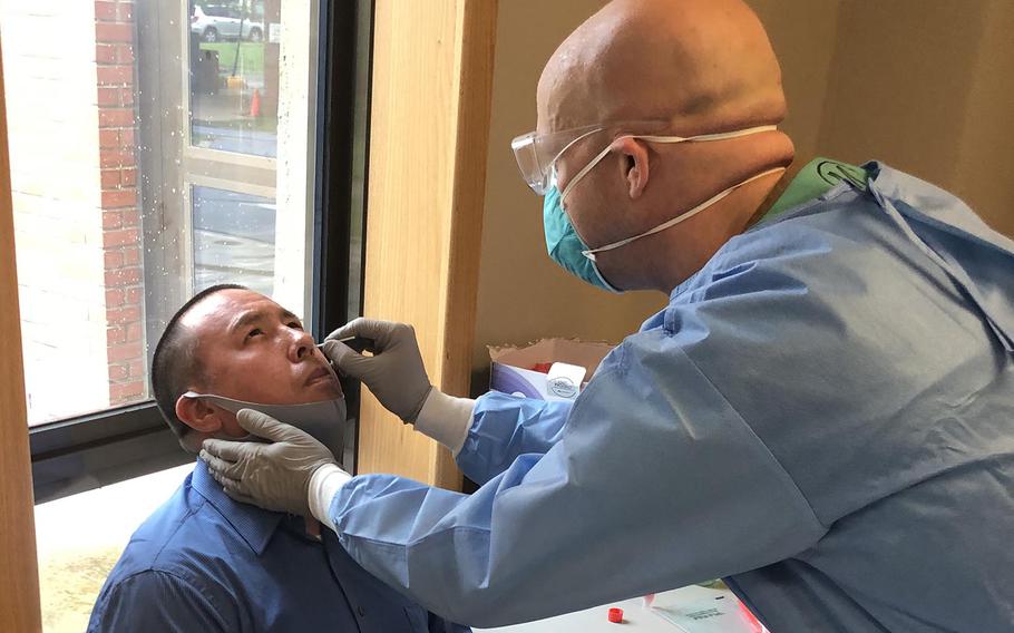 A medical professional from the 65th Medical Brigade conducts a nasal swab on an Eighth Army civilian employee who was selected randomly for Eighth Army COVID-19 Surveillance Testing Aug. 6 on Camp Humphreys, South Korea.