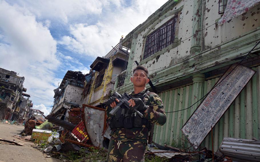 A Philippine soldier stands in Marawi, Philippines, following the city's liberation from Islamic extremists, Nov. 8, 2017. 