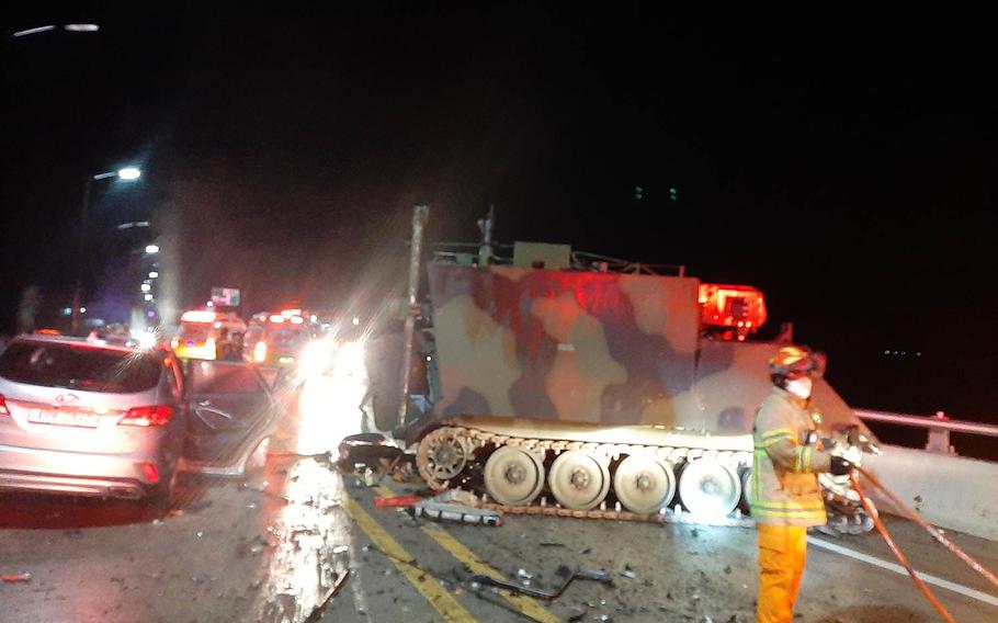 Emergency workers tend to the scene after a collision involving a U.S. armored personnel carrier and a civilian SUV that killed four South Koreans near the Rodriguez Live-Fire Complex in Pocheon, South Korea, Sunday, Aug. 30, 2020. 