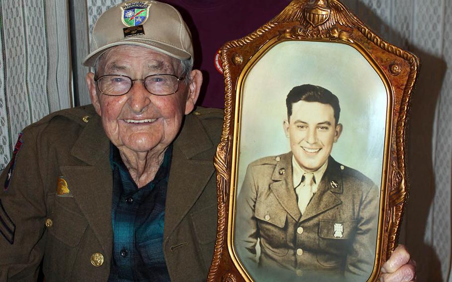 James Richardson, 99, a member of the famed Merrill's Marauders in Burma during World War II, poses with his daughter, Judy Robertson, in February 2020. He holds a photo of his brother, J.C., who was killed in France during the war.