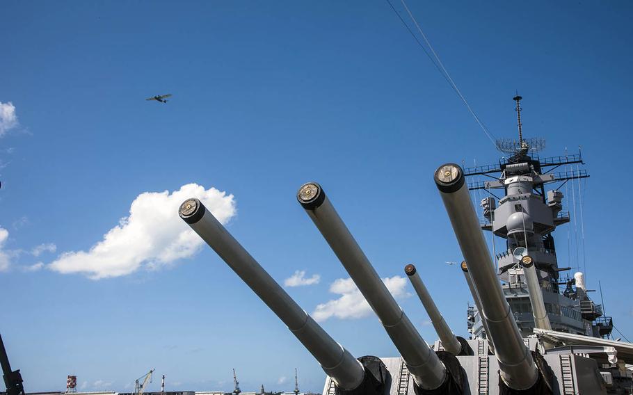 A World War II-era warbird flies over the Battleship Missouri Memorial, moored in Pearl Harbor, Hawaii, during an aerial parade Aug. 30, 2020, as part of the 75th Anniversary of the End of WW II Commemoration.