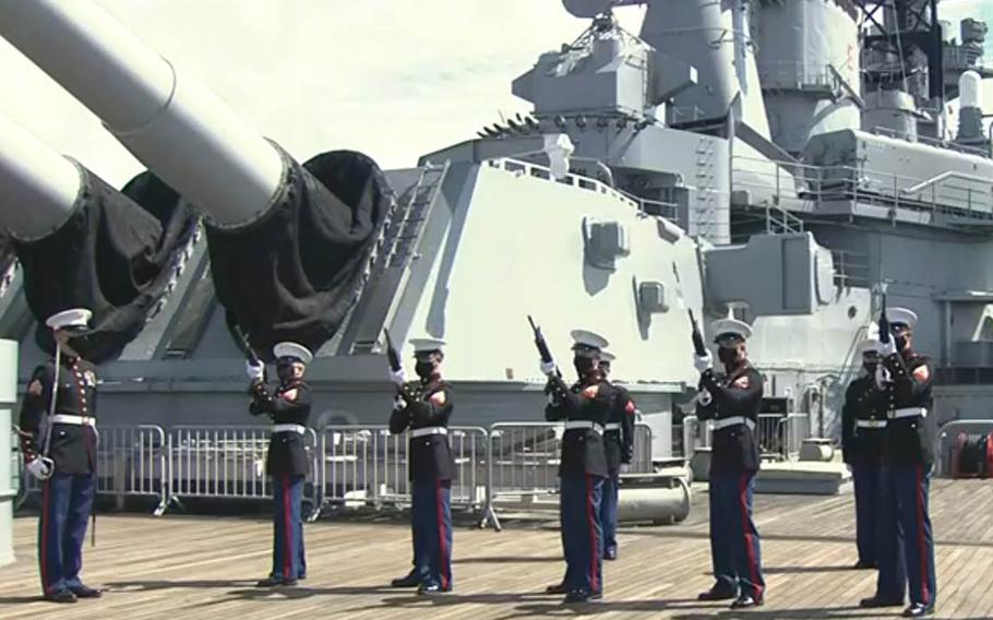 A Marine Corps honor guard fires a rifle salute during a commemoration for the end of World War II at the Battleship Missouri Memorial, Hawaii, Sept. 2, 2020.