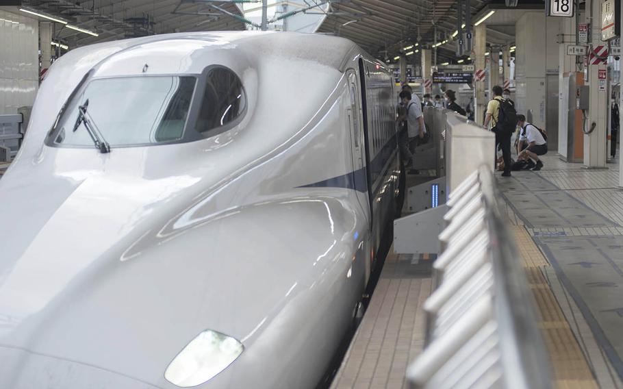 Passengers board a shinkansen, also known as a high-speed bullet train, at Tokyo Station, Sept. 3, 2020.
