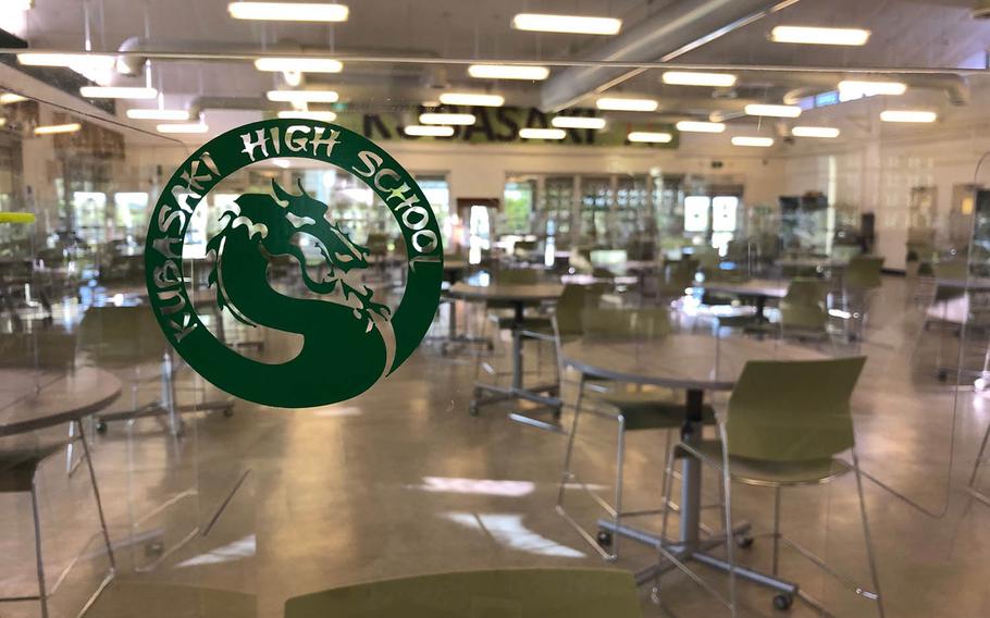 Cafeteria tables equipped with plastic dividers, embossed with the school logo, are seen at Kubasaki High School on Camp Foster, Okinawa, Monday, Sept. 21, 2020.
