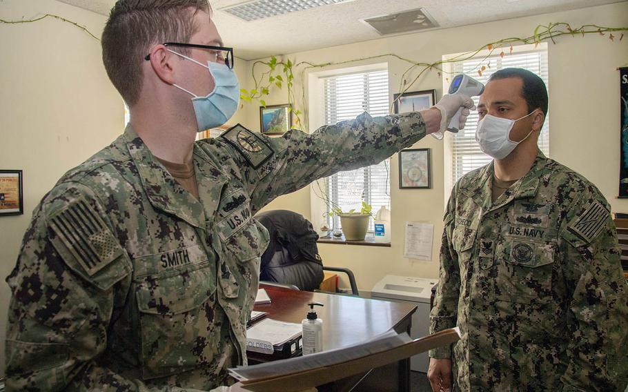 A sailor is screened for coronavirus symptoms at Sasebo Naval Base, Japan, May 13, 2020.