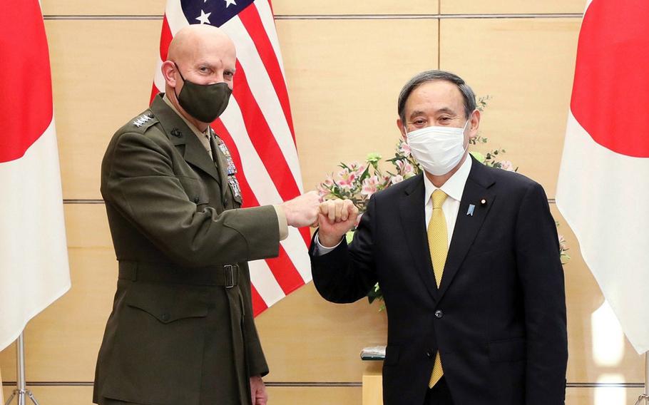 The Marine Corps commandant, Gen. David H. Berger, poses with Japanese Prime Minister Yoshihide Suga in Tokyo, Wednesday, Nov. 18, 2020. 