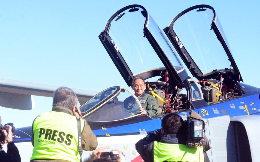 Japanese Prime Minister Yoshihide Suga poses in an F-4EJ "Samurai" Phantom II fighter jet at Iruma Air Base, Japan, Saturday, Nov. 28, 2020.