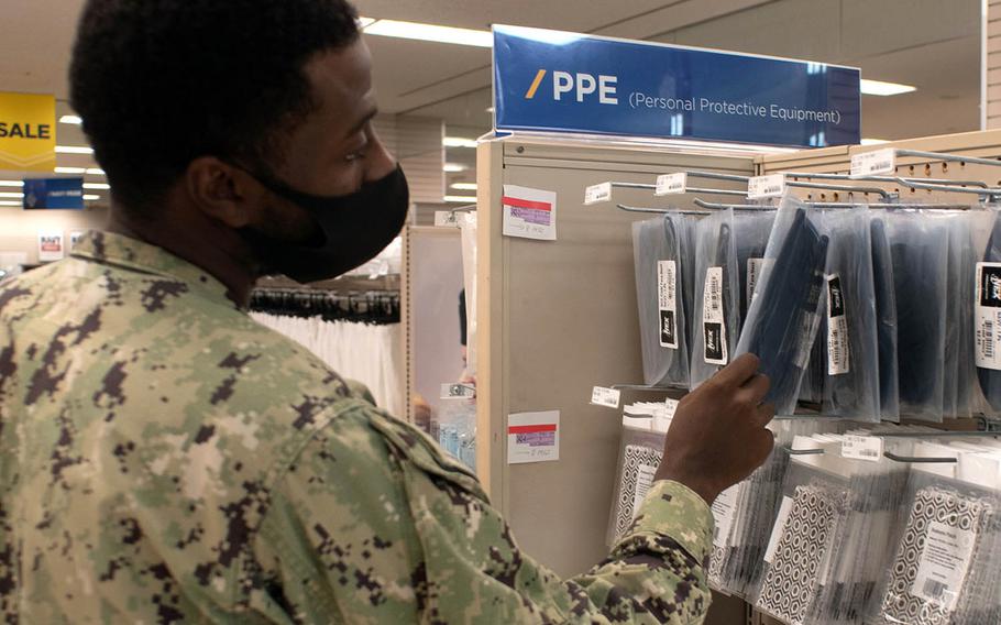 A sailor checks out masks for sale inside the Fleet Store at Yokosuka Naval Base, Japan, Aug. 6, 2020. 
