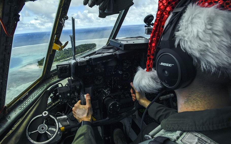 An Air Force pilot flies a C-130 over remote Pacific islands during an Operation Christmas Drop mission in 2016.