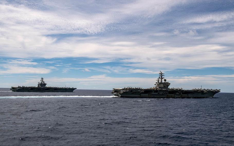 The aircraft carriers USS Nimitz and USS Ronald Reagan sail alongside each other in the South China Sea, July 6, 2020. 