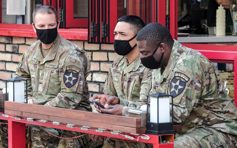 Soldiers assigned to the 2nd Infantry Division wear masks as they wait for their meals outside a restaurant near Osan Air Base, South Korea, Oct. 20, 2020.
