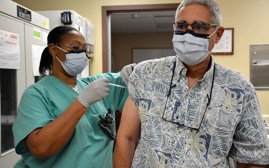 Dr. Scott Belnap, a physician at Tripler Army Medical Center in Honolulu, Hawaii, receives the COVID-19 vaccine, Wednesday, Dec. 16, 2020.