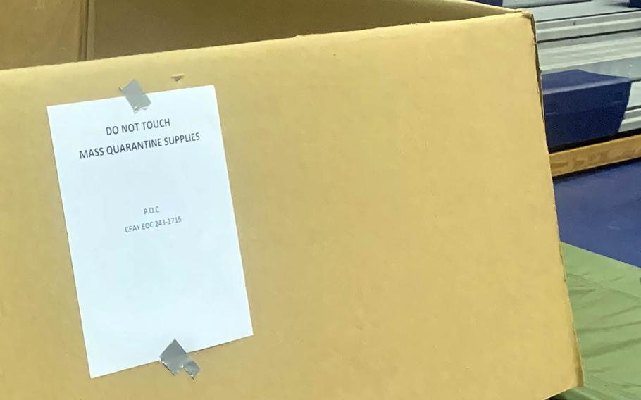 A box labeled "mass quarantine supplies" sits inside the Purdy Gym at Yokosuka Naval Base, Japan, on the final day of the installation's annual flu shot campaign, Dec. 11, 2020.