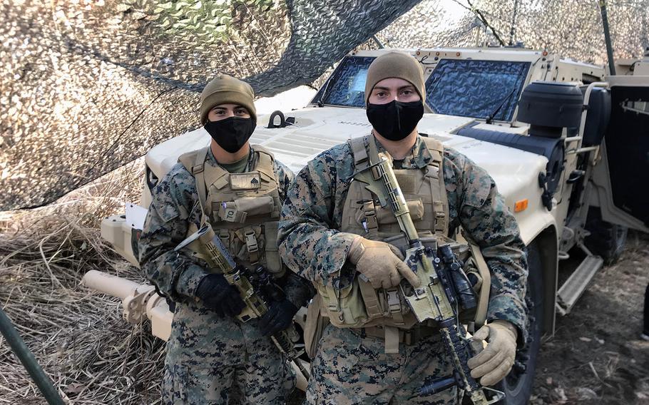 From left, Marine Cpl. Juan Flores, 20, of Ft. Wayne, Ind., and Cpl. Devin Gates, 26, of Panama City, Fla. with a Joint Light Tactical Vehicle during training in Gunma prefecture, Japan, Dec. 15, 2020.