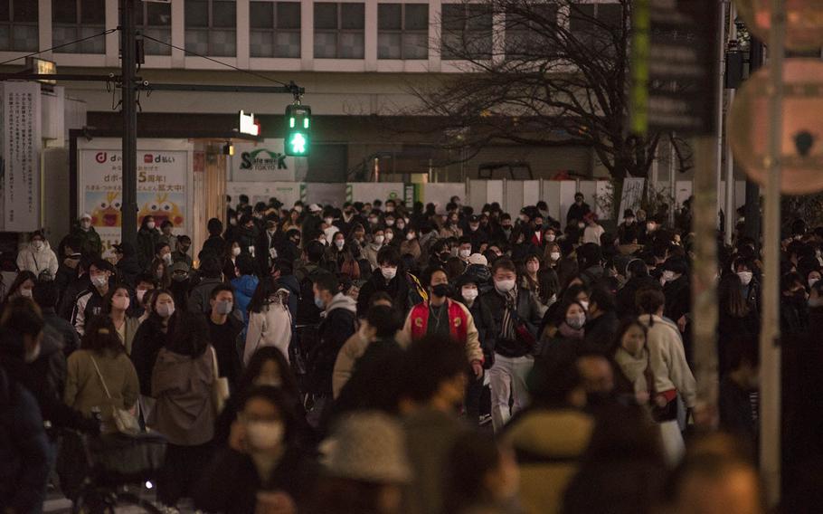 Hundreds scramble across the Shibuya crossing in Tokyo on Sunday, Dec. 20, 2020. 