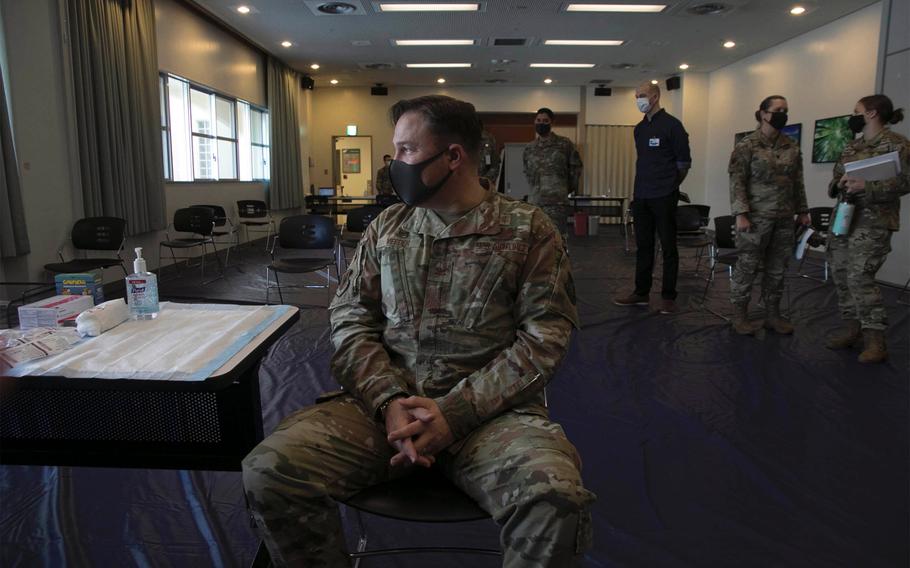 Air Force Col. Jay Veeder, 18th Medical Group commander, waits for the Moderna coronavirus vaccine at Kadena Air Base, Okinawa, Japan, on Monday, Dec. 28, 2020.