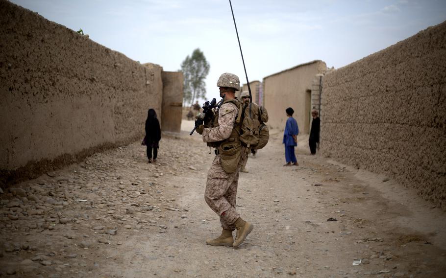 A U.S. Marine with Task Force Southwest moves through a village during a patrol near Bost Kalay, Afghanistan, in June 2018. The Trump administration says it has intelligence that China offered to pay militants in Afghanistan to attack American troops, but unnamed government officials are dismissing the evidence against Beijing as "very thin," U.S. media reports published in December 2020 say.