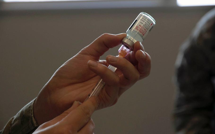 An Air Force health-care professional loads a syringe with Moderna's COVID-19 vaccine at Kadena Air Base on Okinawa, Japan, on Monday, Dec. 28, 2020.