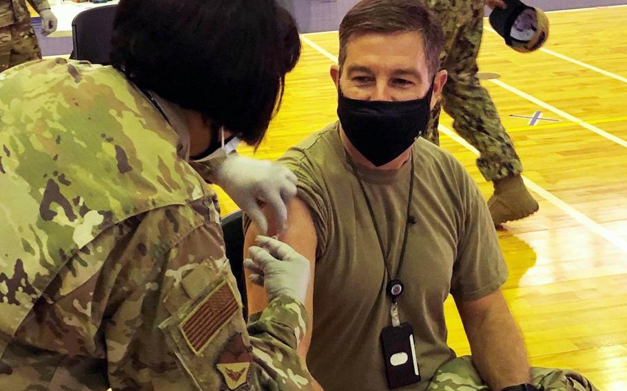 Chief Master Sgt. Rick Winegardner Jr., senior enlisted leader for U.S. Forces Japan, receives the Moderna coronavirus vaccine at Yokota Air Base, Japan, Wednesday, Jan. 13, 2021.